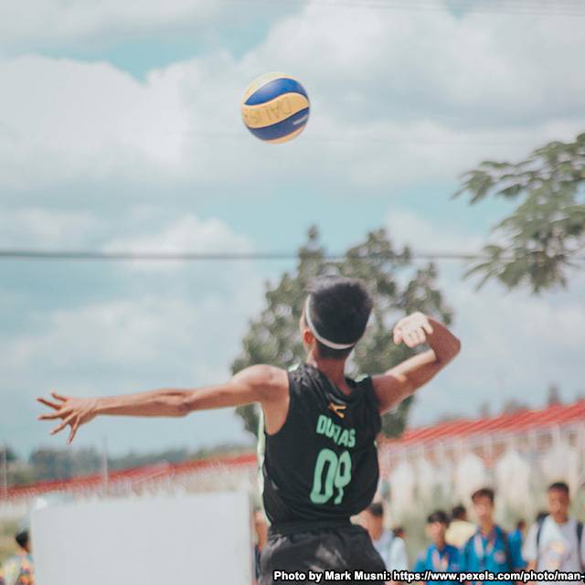 Club Sports Volleyball player spiking the ball.