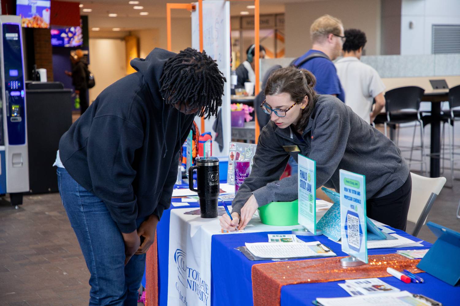 Student signs in at Finals Study Jam