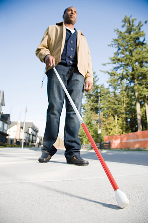 Student walking with cane.