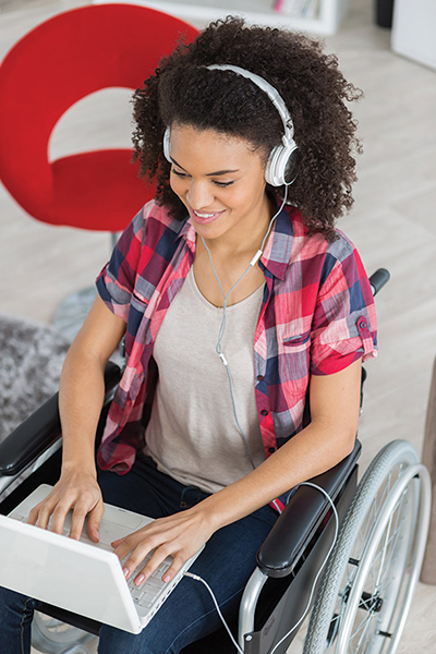 Student in wheelchair using a laptop.