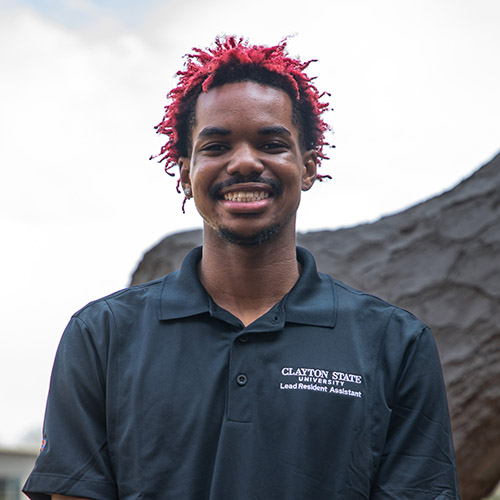 Image of Nehemiah Horton, wearing a CSU Lead Resident Assistant polo-style shirt