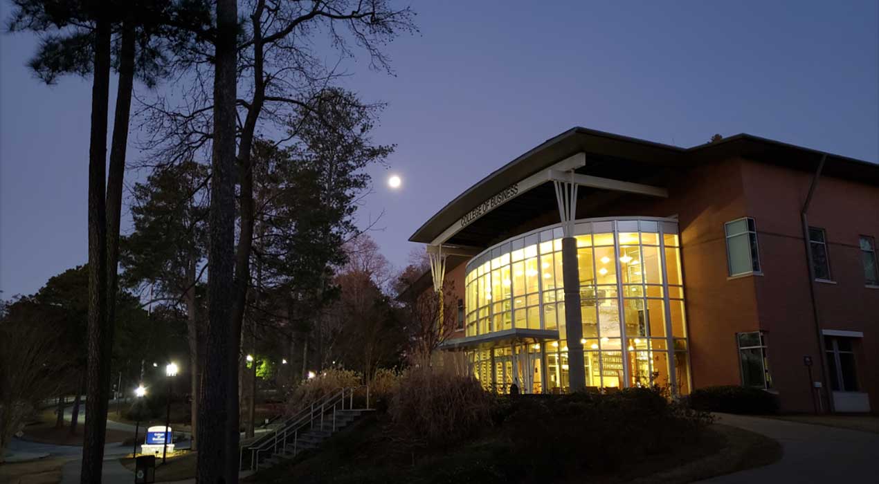 Night settles over Clayton State University's College of Business building.