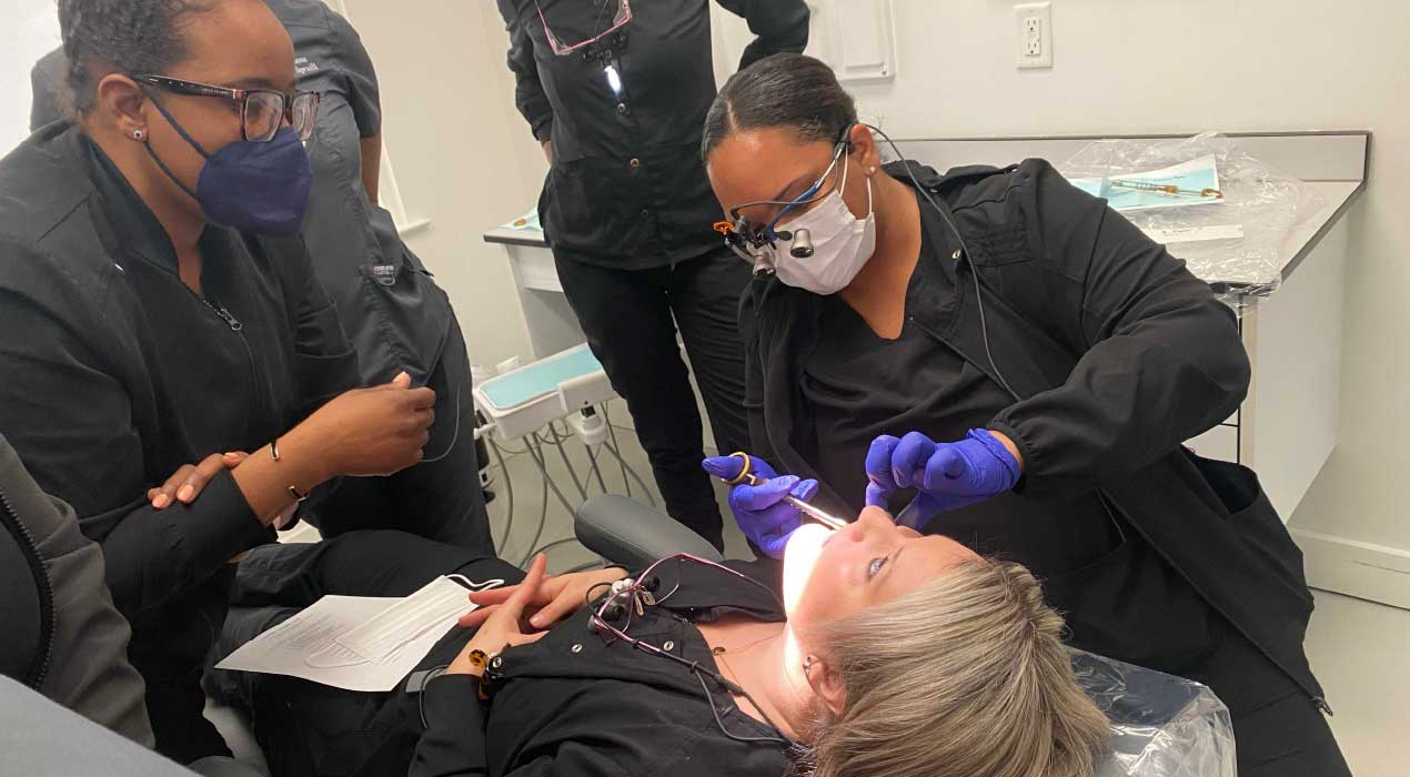 Dental hygienists administer local anesthesia to Clayton State University's Heather Eddy 